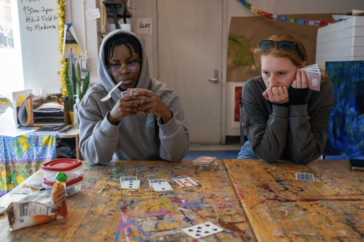 March - Trinity Harris and Ebie Lamb play card games during the extended lunch time on pi day. Harris and Lamb are both focused on getting the win. Playing games gets competitive, Harris said. Were all great friends but we get really annoyed at each other while we play.